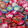 assortment of colorful pins buttons